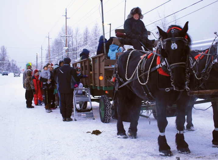 Jon Nauman, owner of the Horse-Drawn Carriage Co., leads hay rides for families at the Mountain View Winter Festival.